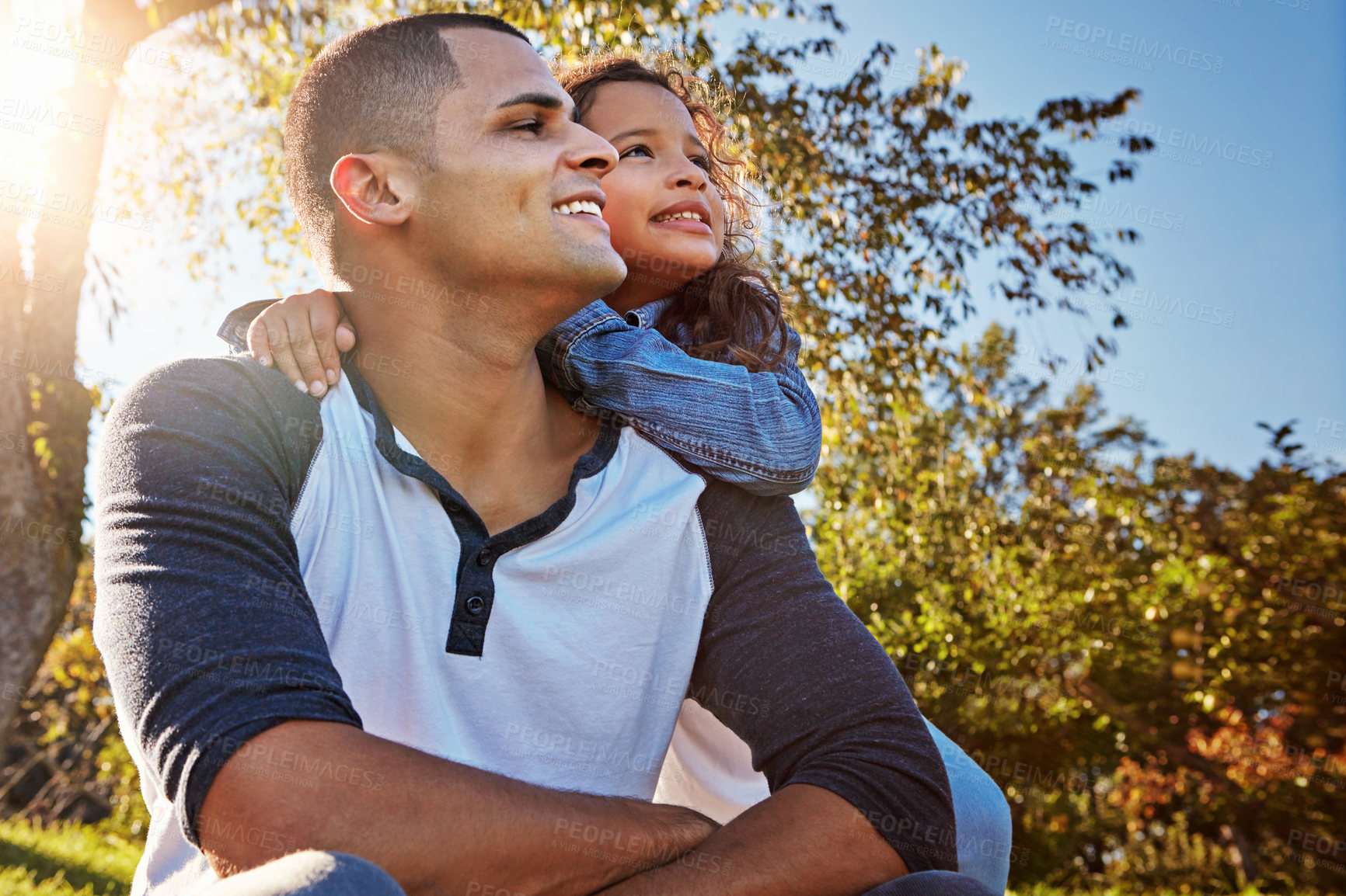 Buy stock photo Shot of a happy father and daughter spending time together outdoors