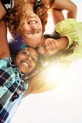 Buy stock photo Happy, huddle and portrait of children in park for bonding, playing and fun together outdoors. Diversity, youth and low angle of girls hug in circle for childhood, friendship and relax on weekend