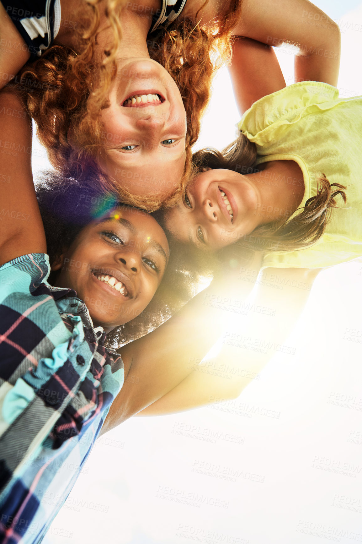 Buy stock photo Happy, huddle and portrait of children in park for bonding, playing and fun together outdoors. Diversity, youth and low angle of girls hug in circle for childhood, friendship and relax on weekend