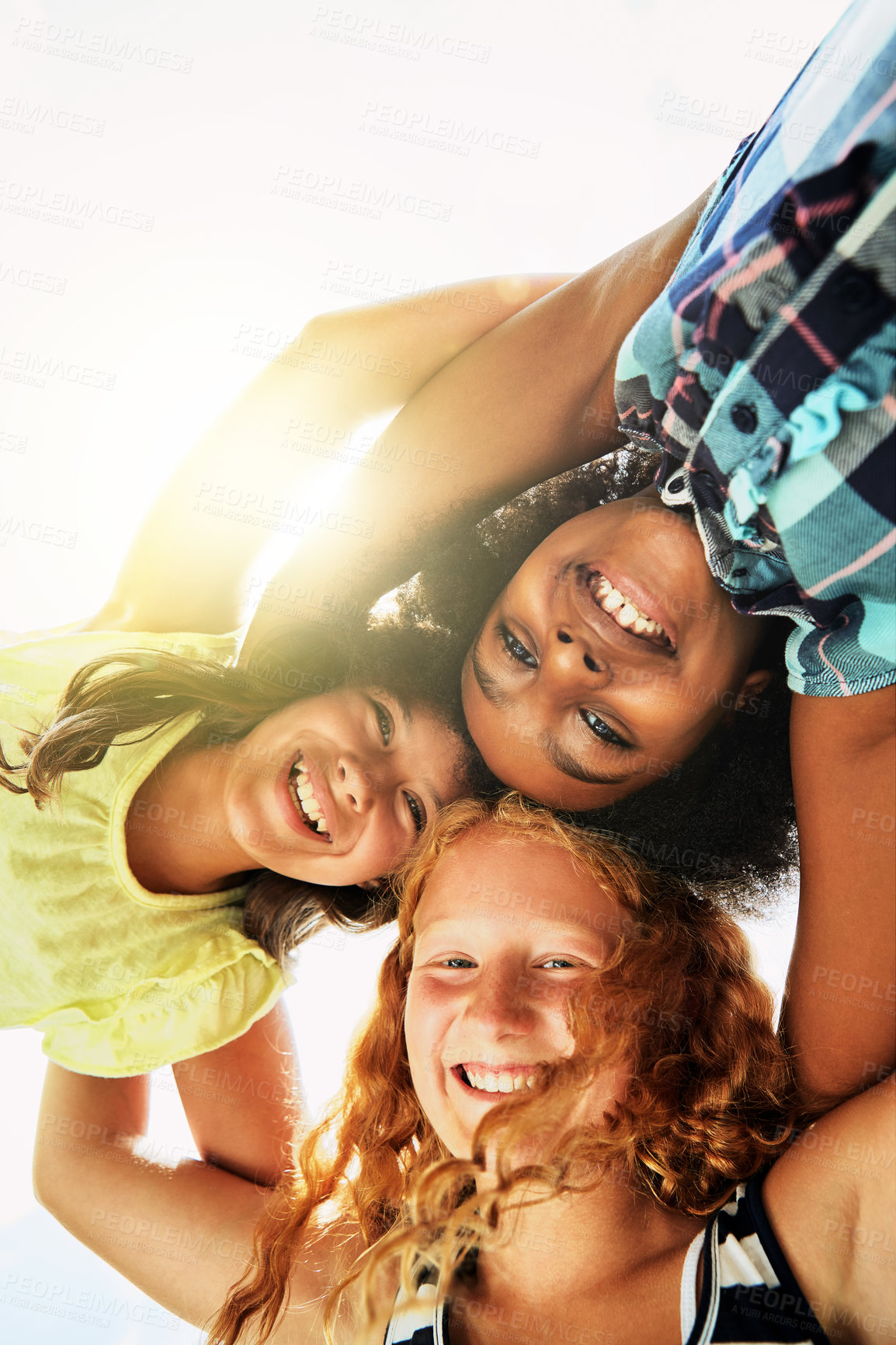 Buy stock photo Happy, huddle and portrait of children outdoor for bonding, playing and fun together on weekend. Diversity, youth and low angle of girls hug in circle for childhood, friendship or relax with sunshine