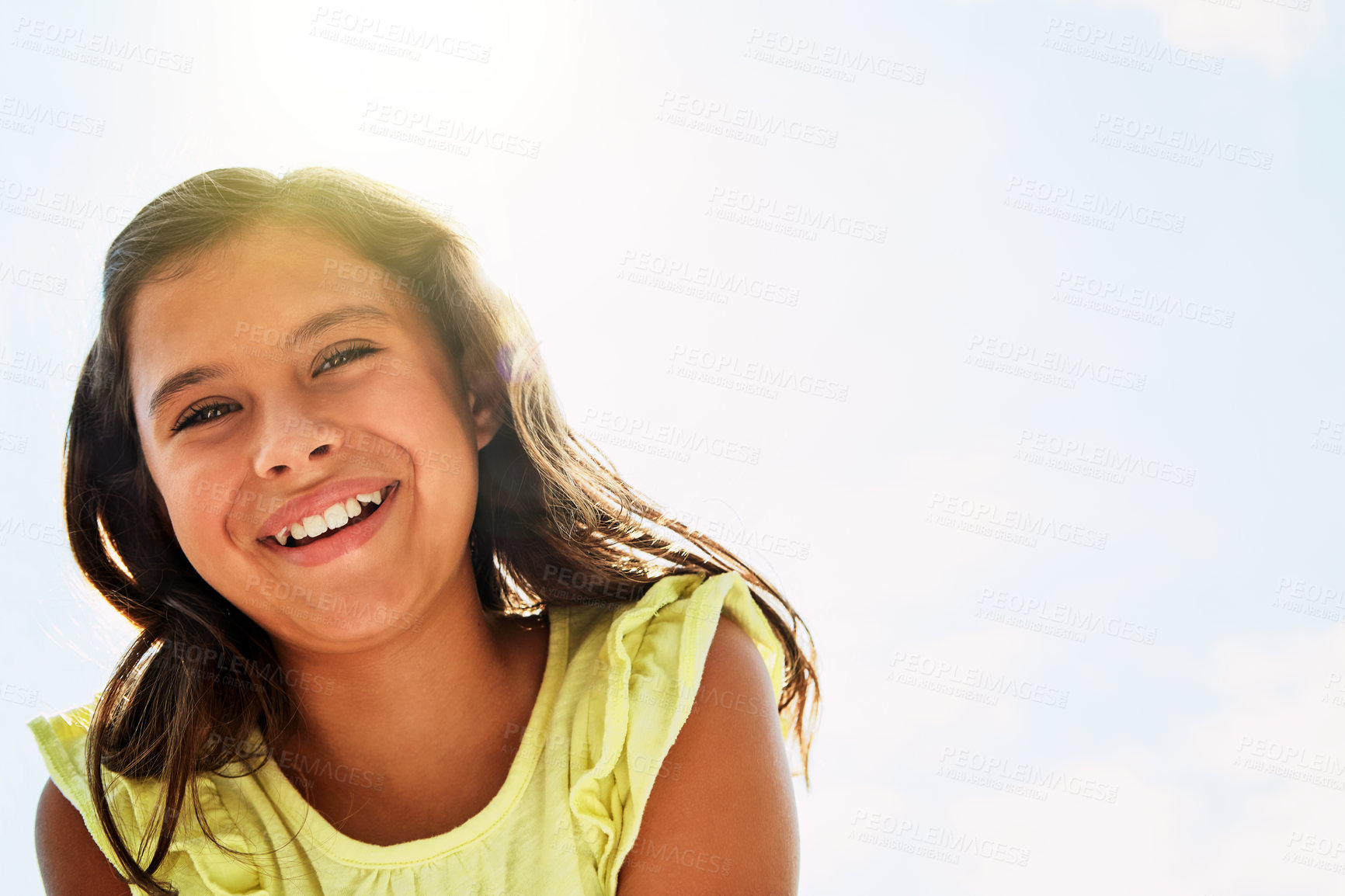 Buy stock photo Portrait of a happy girl standing outside on a bright summer’s day