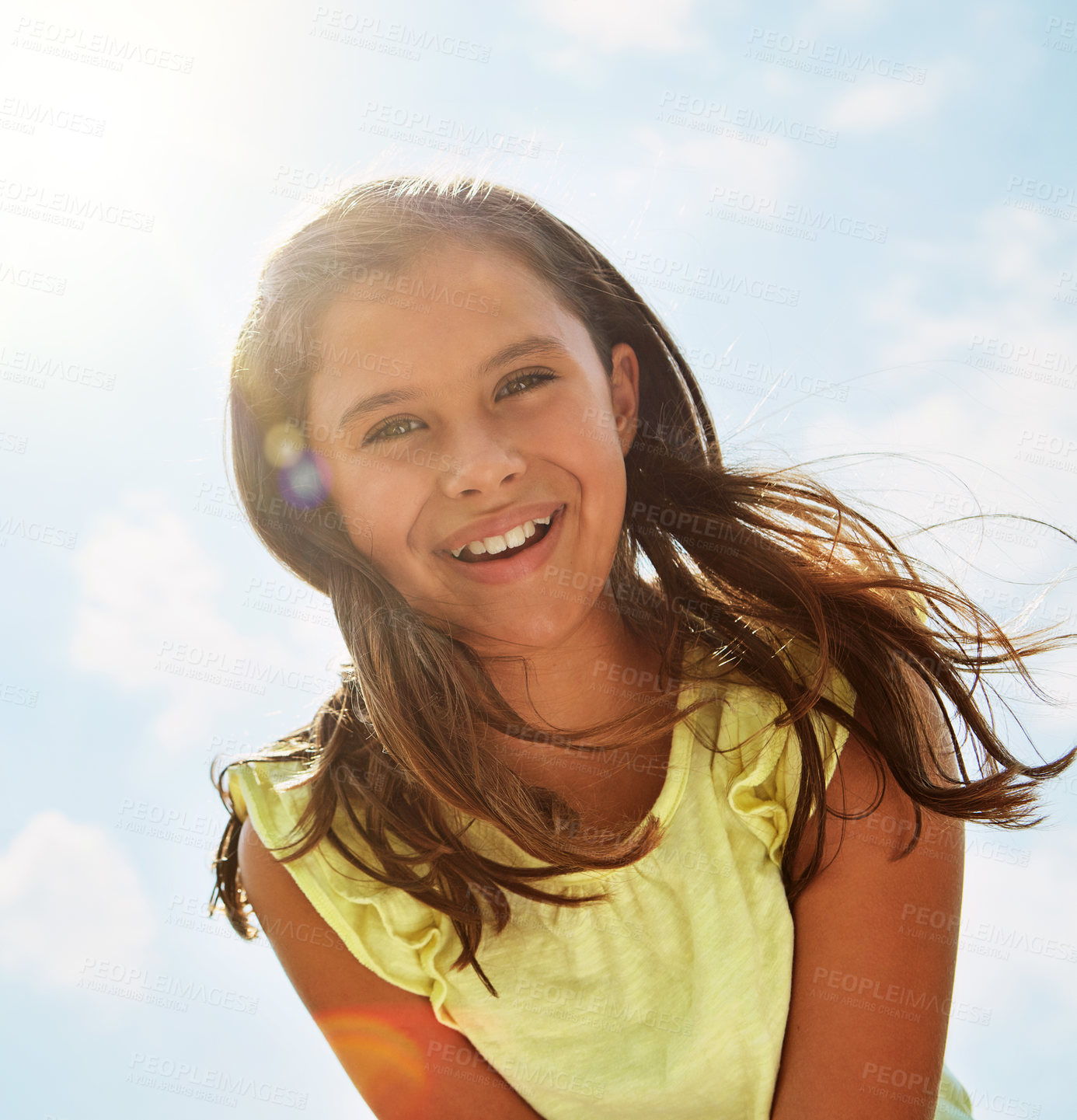 Buy stock photo Portrait of a happy girl standing outside on a bright summer’s day