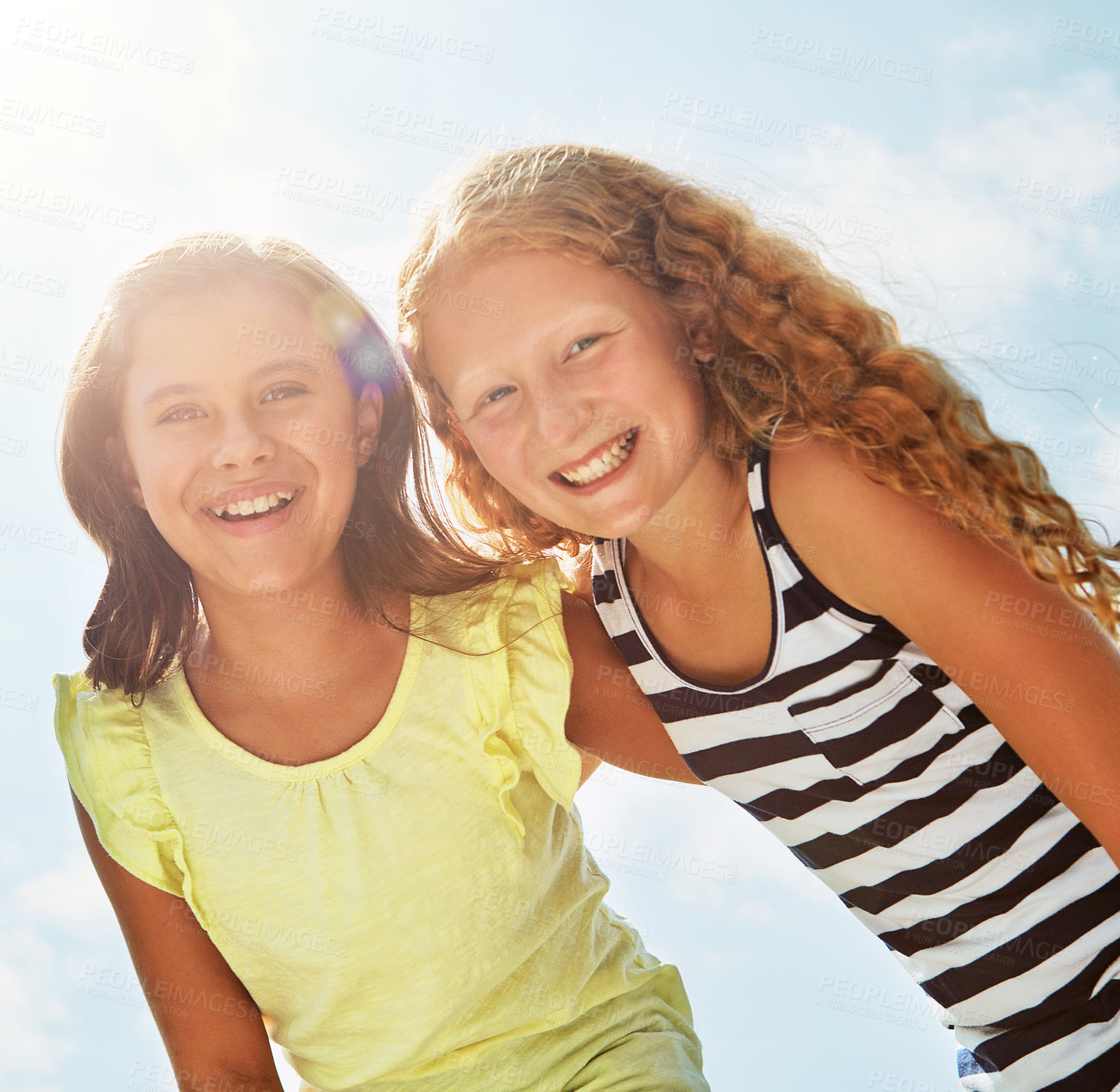 Buy stock photo Portrait of two happy young friends hanging out together on a bright day outside