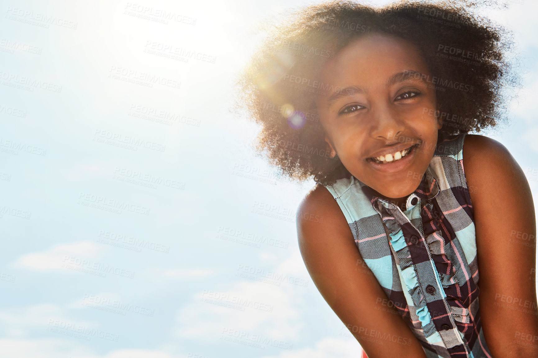 Buy stock photo Portrait of a happy girl standing outside on a bright summer’s day