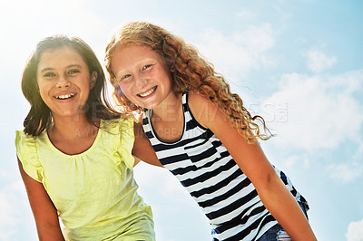 Buy stock photo Portrait of two happy young friends hanging out together on a bright day outside