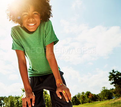 Buy stock photo Portrait of a happy boy standing outside on a bright summer’s day