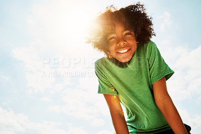 Buy stock photo Portrait of a happy boy standing outside on a bright summer’s day