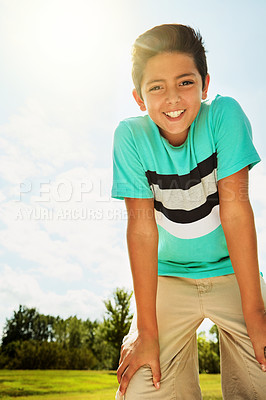 Buy stock photo Portrait of a happy boy standing outside on a bright summer’s day