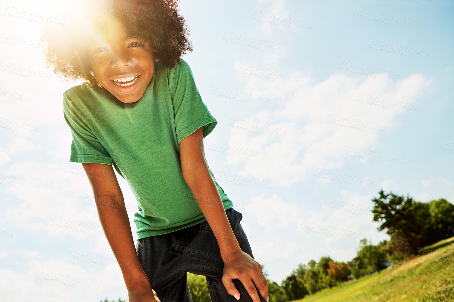 Buy stock photo Portrait of a happy boy standing outside on a bright summer’s day