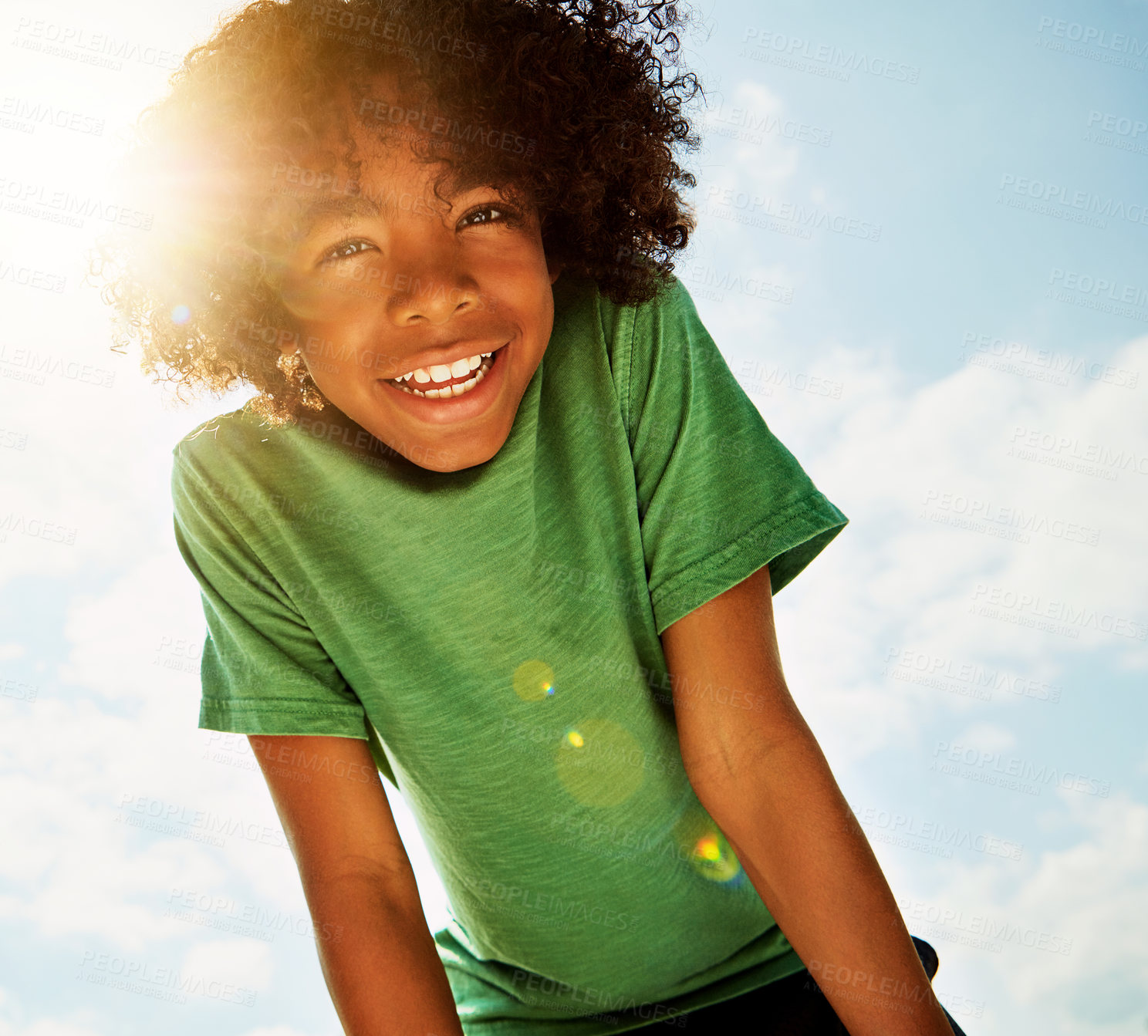 Buy stock photo Portrait of a happy boy standing outside on a bright summer’s day