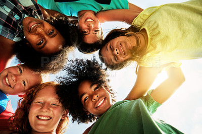 Buy stock photo Happy, friends and portrait of children huddle for bonding, playing and fun together outdoors. Diversity, youth and low angle of kids hug in circle for childhood, friendship and relax on weekend