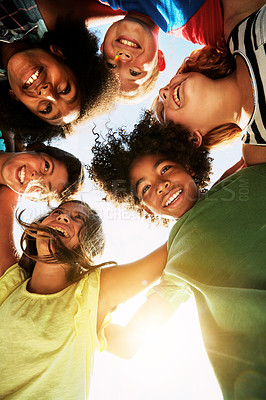 Buy stock photo Happy, huddle and circle of children in park for bonding, playing and fun together outdoors. Diversity, youth and low angle of kids hug for childhood, friendship and relax on weekend or holiday