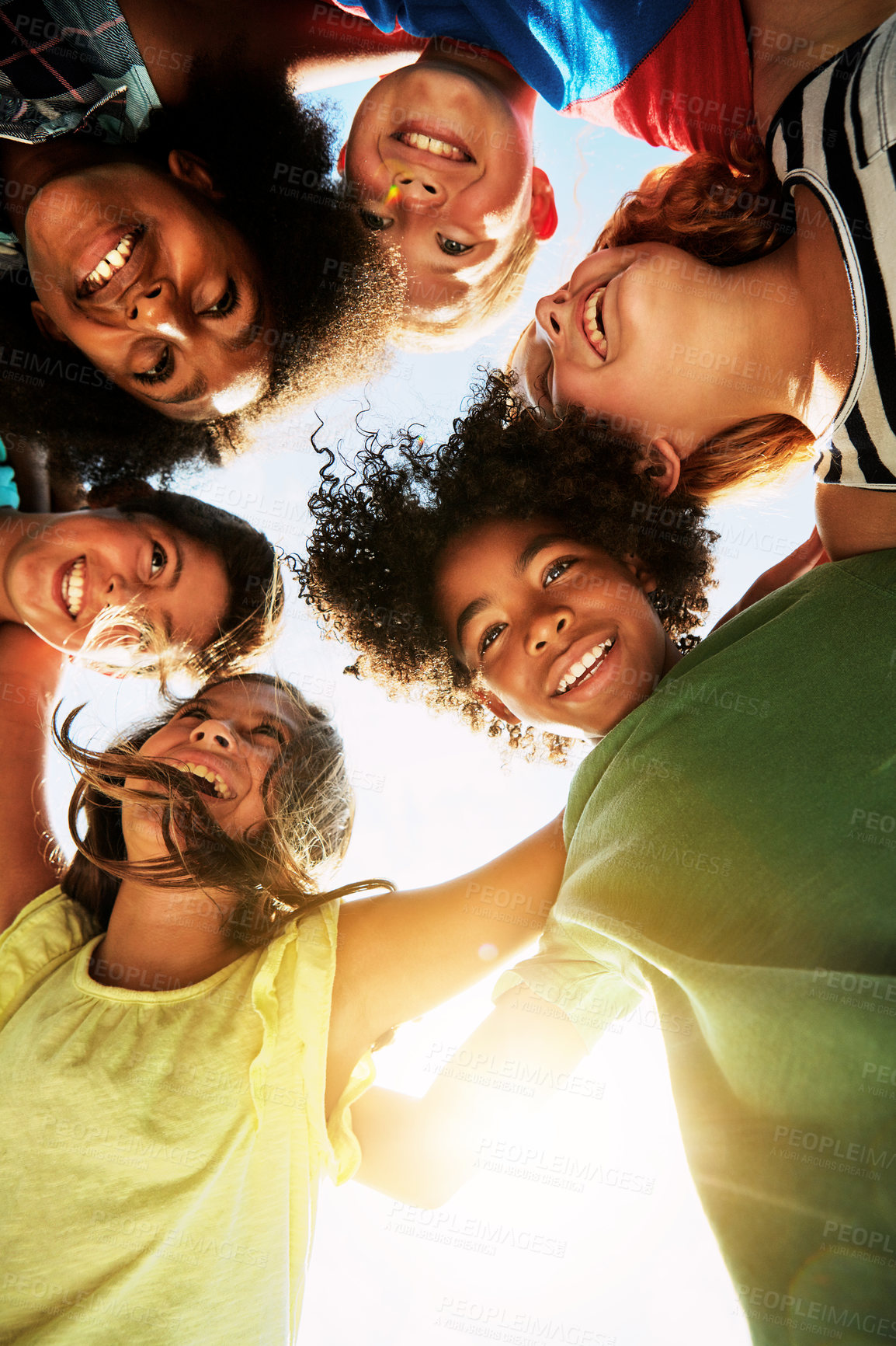 Buy stock photo Happy, huddle and circle of children in park for bonding, playing and fun together outdoors. Diversity, youth and low angle of kids hug for childhood, friendship and relax on weekend or holiday