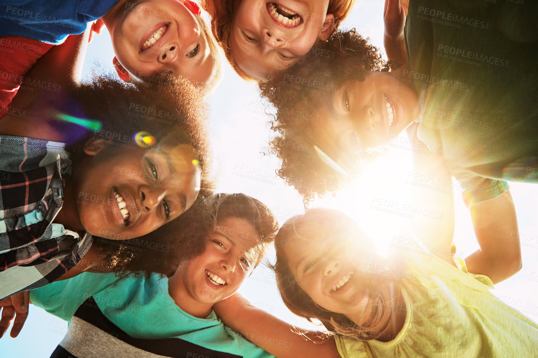 Buy stock photo Happy, sunshine and portrait of children in huddle for bonding, playing and fun together outdoors. Diversity, youth and low angle of kids hug in circle for childhood, friendship and relax on weekend