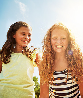 Buy stock photo Portrait of two happy young friends hanging out together on a bright day outside