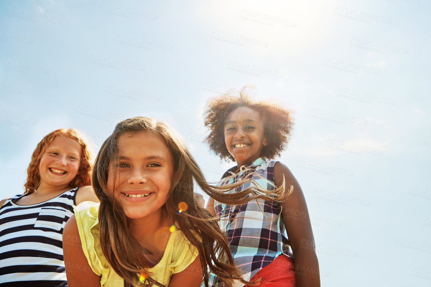 Buy stock photo Portrait of a group of diverse and happy kids hanging out together on a bright day outside