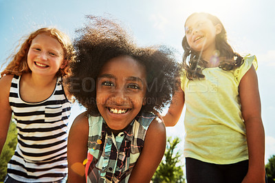 Buy stock photo Portrait of a group of diverse and happy kids hanging out together on a bright day outside