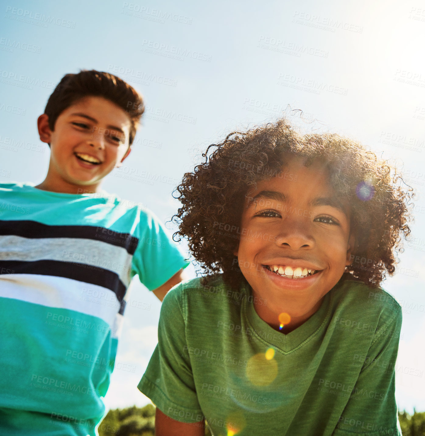 Buy stock photo Portrait of two happy young friends hanging out together on a bright day outside