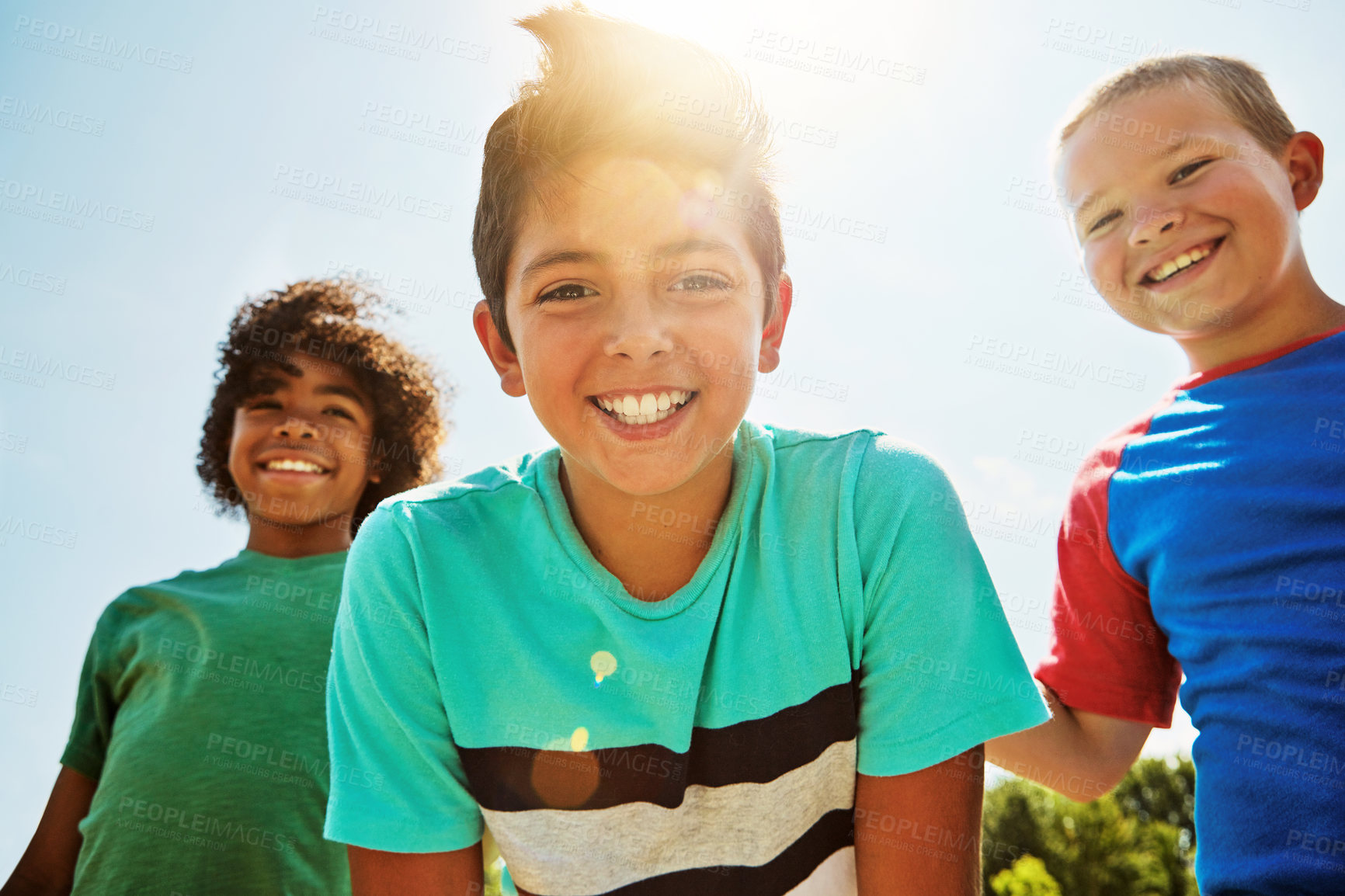 Buy stock photo Portrait of a group of diverse and happy kids hanging out together on a bright day outside