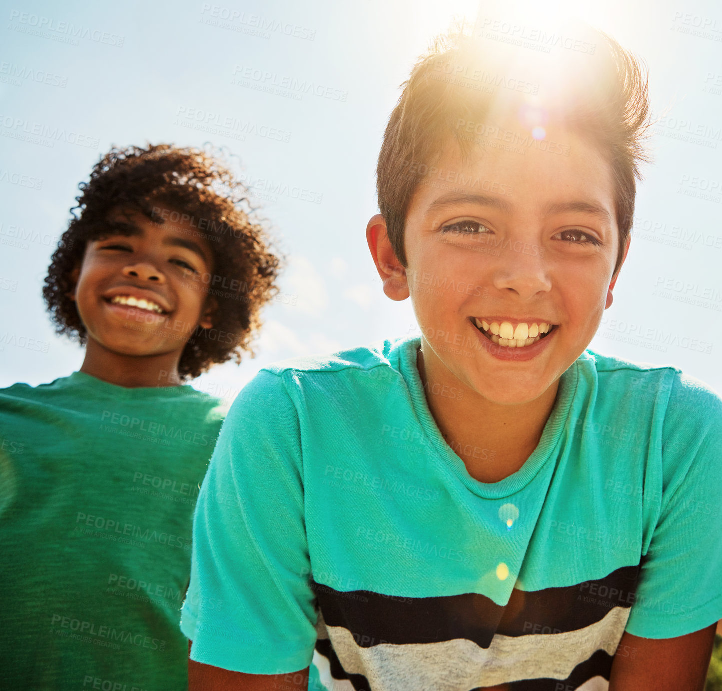 Buy stock photo Portrait of two happy young friends hanging out together on a bright day outside