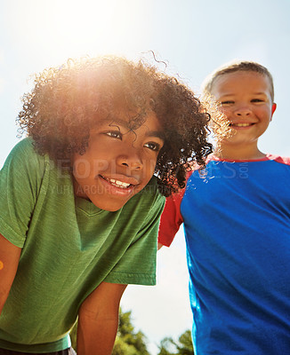 Buy stock photo Shot of two happy young friends hanging out together on a bright day outside