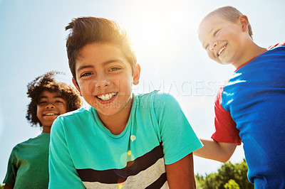 Buy stock photo Portrait of a group of diverse and happy kids hanging out together on a bright day outside