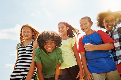 Buy stock photo Portrait of a group of diverse and happy kids hanging out together on a bright day outside