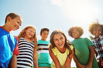 Buy stock photo Portrait of a group of diverse and happy kids hanging out together on a bright day outside