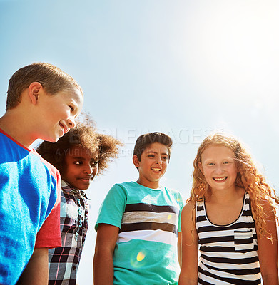 Buy stock photo Portrait of a group of diverse and happy kids hanging out together on a bright day outside