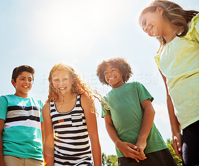 Buy stock photo Portrait of a group of diverse and happy kids hanging out together on a bright day outside