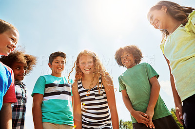 Buy stock photo Portrait of a group of diverse and happy kids hanging out together on a bright day outside