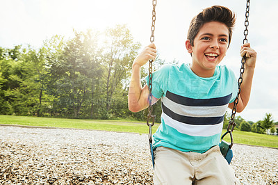 Buy stock photo Happy, nature and boy on swing in park for fun, adventure and play time on holiday or weekend trip. Smile, cute and child or kid on equipment on playground in outdoor field on vacation in Canada.