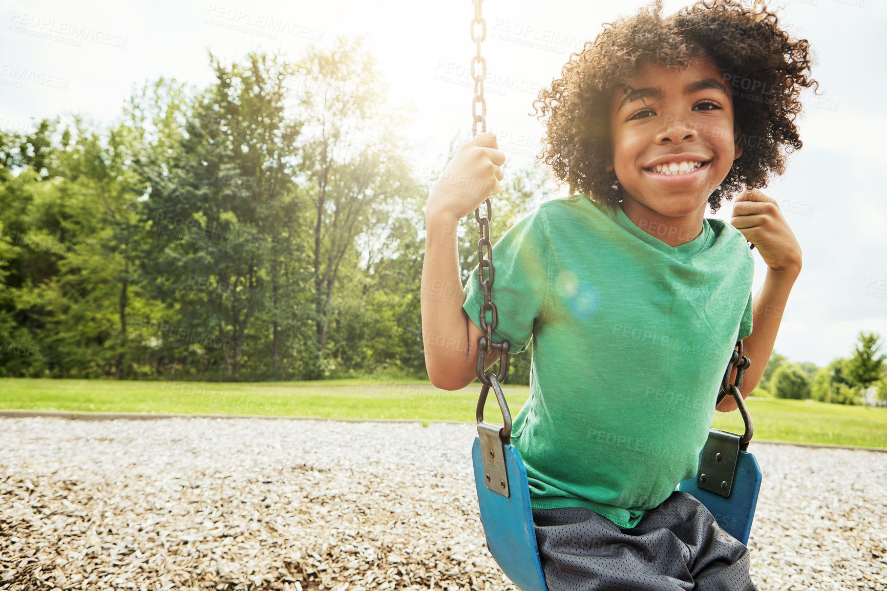 Buy stock photo African boy, portrait and smile with park, swing and nature for outdoor fun and play with fresh air. Child, tree and playground with summer, freedom and school holiday or break outside with happiness