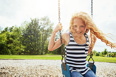 Buy stock photo Child, portrait and smile with park, swing or nature for outdoor fun or play with fresh air. Girl, development and playground with summer, freedom and school holiday or break outside for happiness