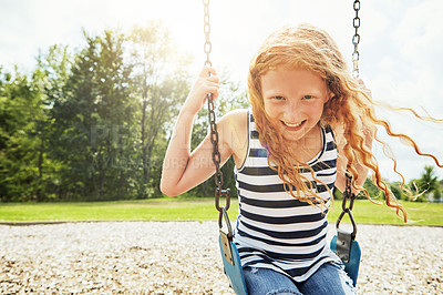 Buy stock photo Girl, portrait and smile with nature, swing and park for outdoor fun or play with fresh air. Child, playground and development with summer, freedom and school holiday or break outside for happiness