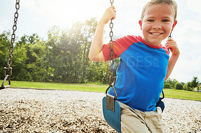 Buy stock photo Young child, portrait and smile with swing, park and nature for outdoor fun and play with fresh air. Boy, tree and playground with summer, freedom and school holiday or break outside with happiness