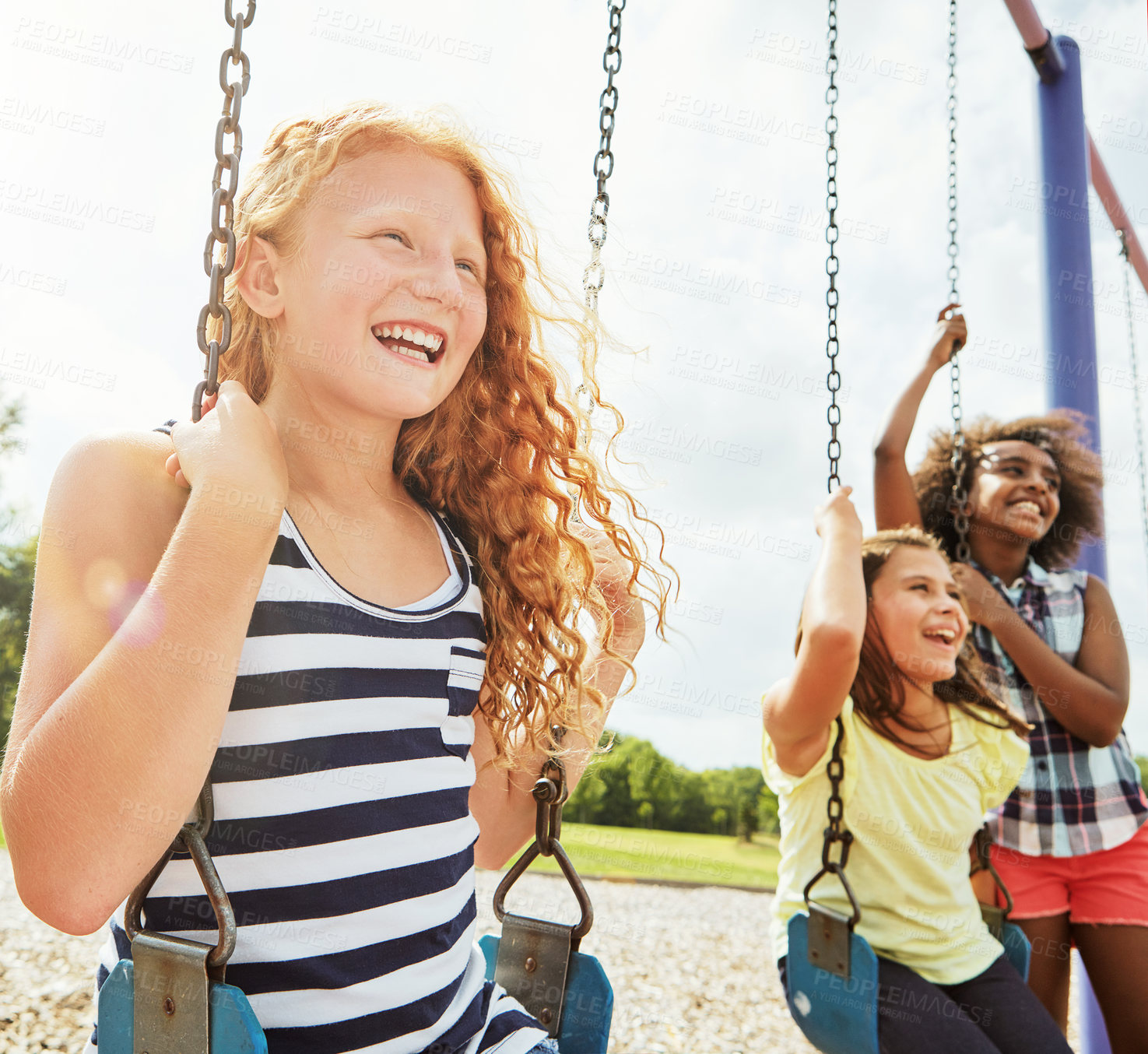 Buy stock photo Cropped shot of young girls playing on the swings at the park