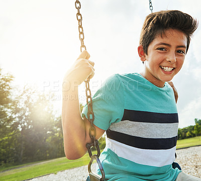 Buy stock photo Boy, portrait and smile with playground, swing and nature for outdoor fun and play with fresh air. Child, tree and park with summer, freedom and holiday or youth break outside with happiness