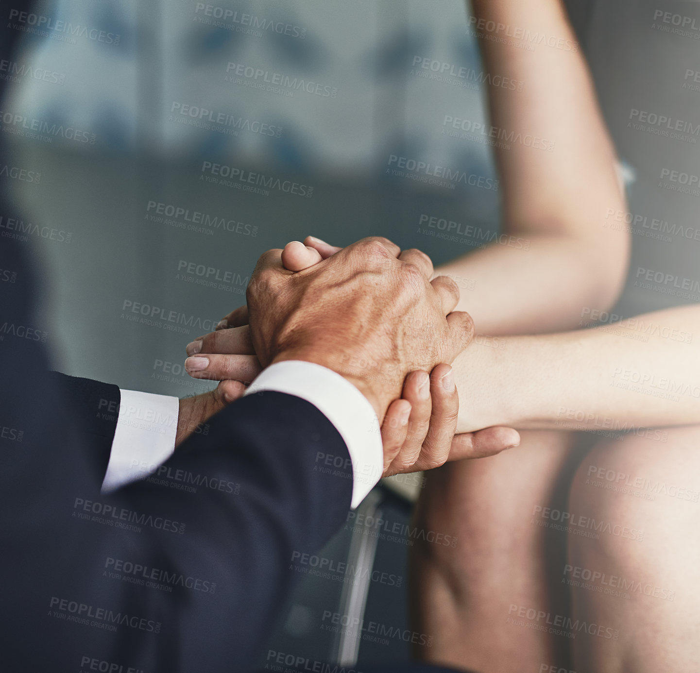 Buy stock photo Cropped shot of two compassionate colleagues holding hands