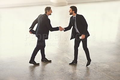Buy stock photo High angle shot of businesspeople standing in a office lobby 