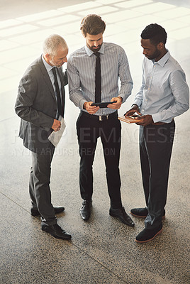 Buy stock photo High angle shot of businesspeople standing in a office lobby 