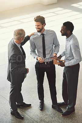 Buy stock photo High angle shot of businesspeople standing in a office lobby