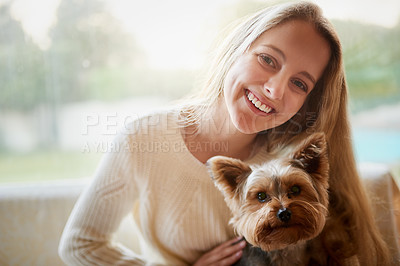 Buy stock photo Portrait of an attractive young woman and her puppy sitting on the sofa at home