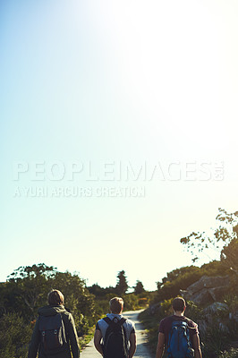 Buy stock photo Rearview shot of a group of friends walking along a hiking path together