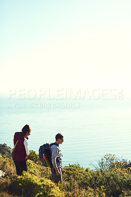 Buy stock photo Shot of a young couple exploring the outdoors on a hiking trail