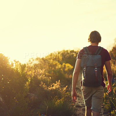 Buy stock photo Rearview shot of a young man exploring the outdoors alone on a hiking trail