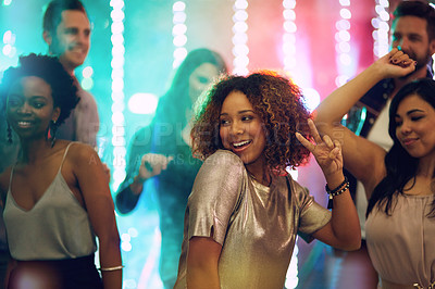 Buy stock photo Shot of a group of young people having fun in a nightclub