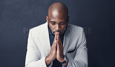 Buy stock photo Praying, thinking and business man with faith for career, job or opportunity, asking god for help and support. Corporate african person with prayer sign, sad or hope isolated on dark gray background