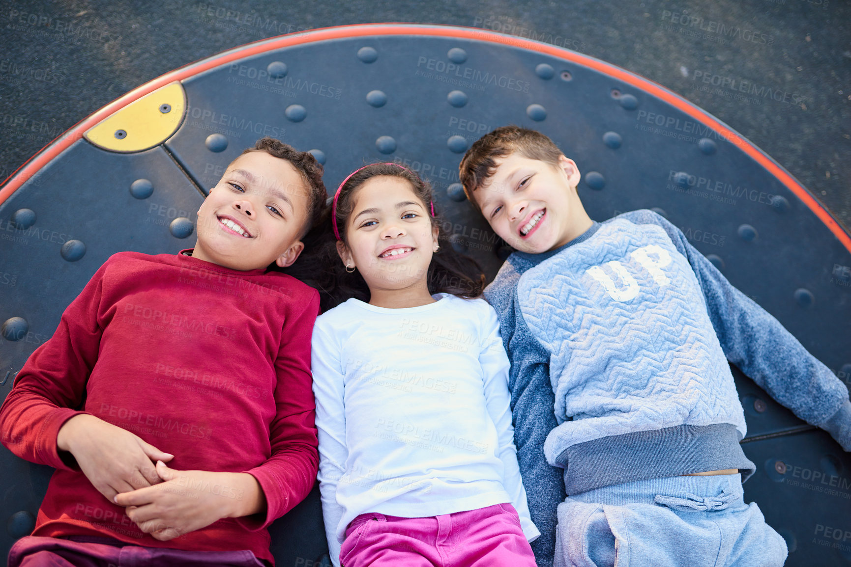 Buy stock photo Portrait of three young siblings playing together at the park