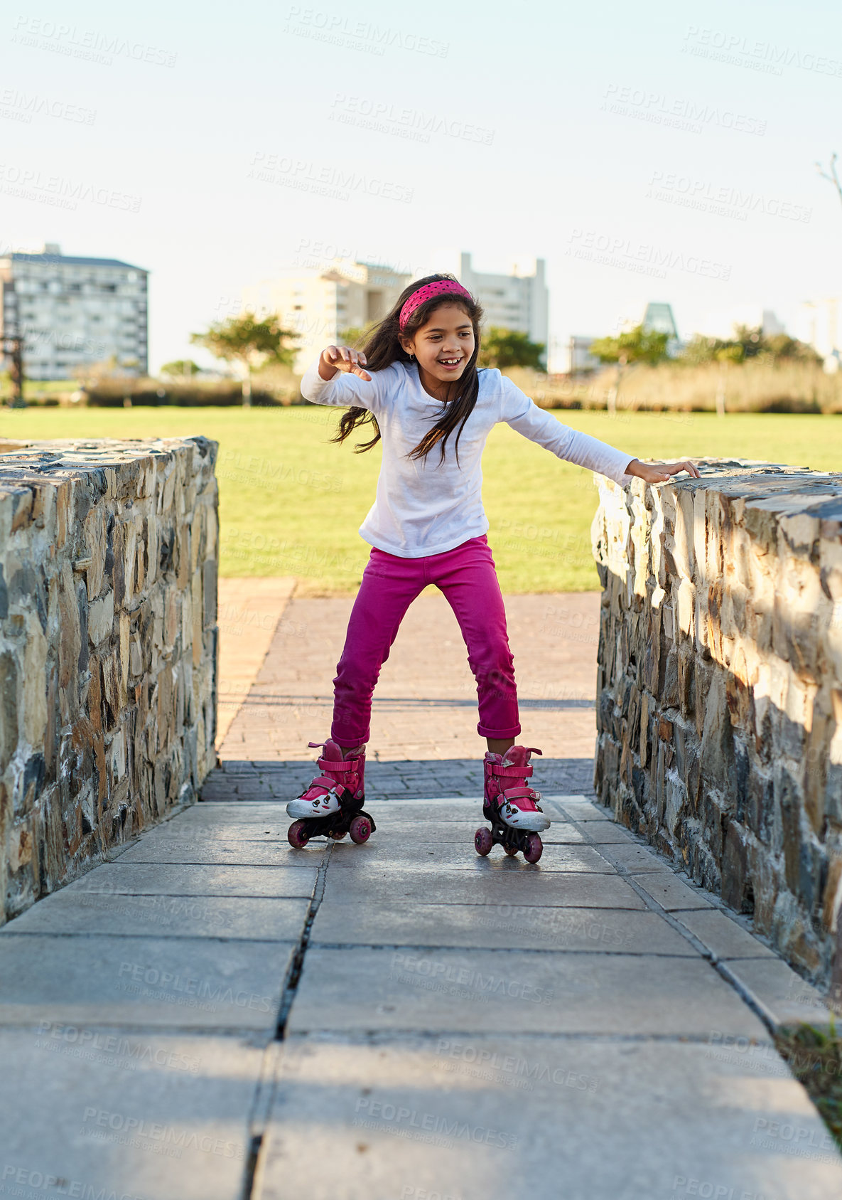 Buy stock photo Outdoor, kid and roller skating with happiness, playing and learning with confidence. Young girl, skater and fun in park for practice, exercising and child development with sports for growth